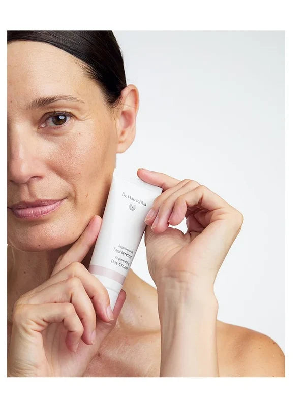 Model holding Dr Hauschka Regenerating Day Cream