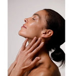 Model smoothing Dr Hauschka Regenerating Night Serum Intensive onto her neck