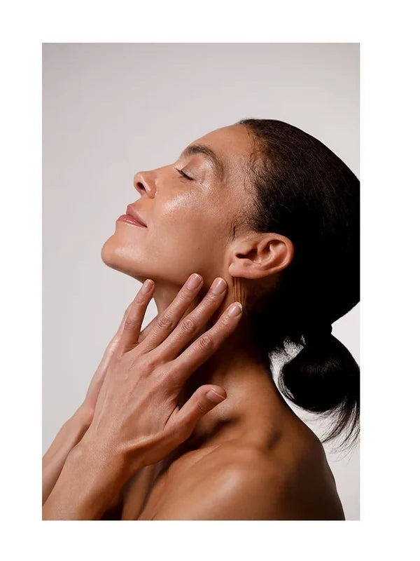 Model smoothing Dr Hauschka Regenerating Night Serum Intensive onto her neck