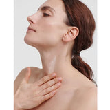 Model applying Dr Hauschka Regenerating Neck and Decollete Cream
