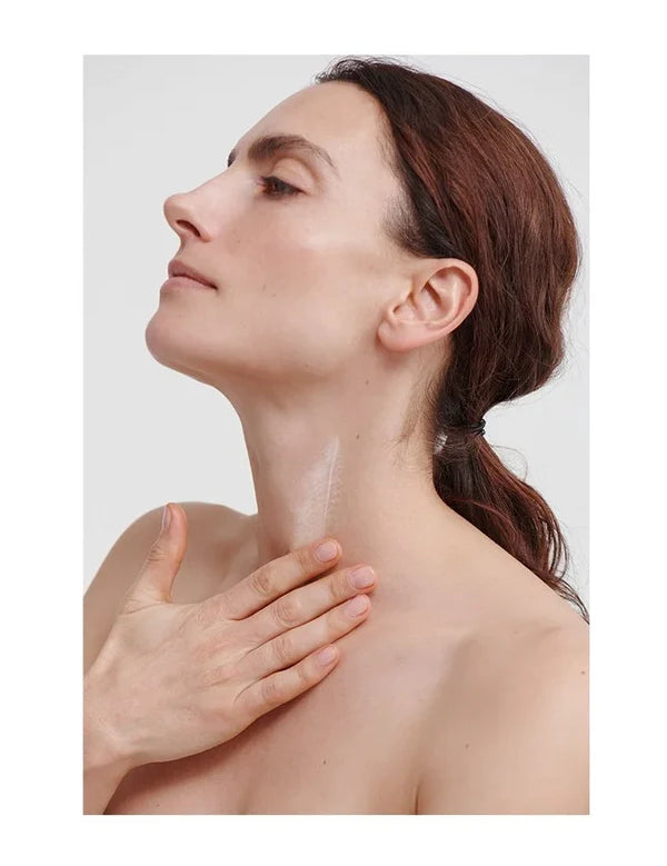 Model applying Dr Hauschka Regenerating Neck and Decollete Cream
