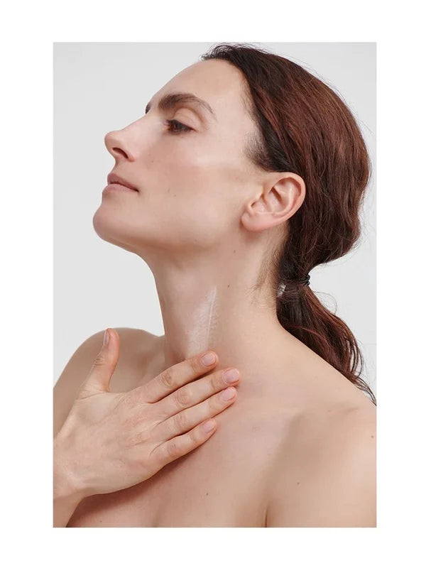 Model applying Dr Hauschka Regenerating Neck and Decollete Cream