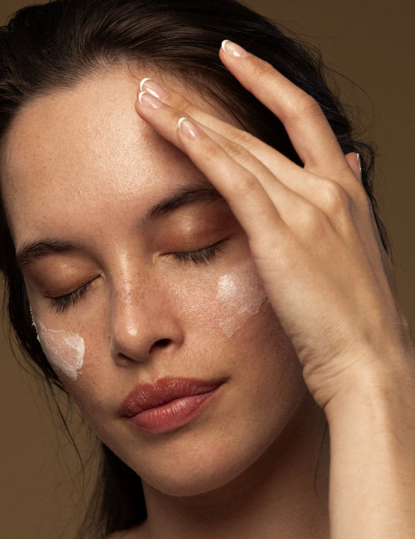 Model applying Antipodes Rejoice Light Facial Day Cream