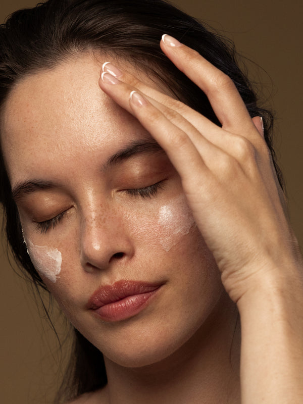 Model applying Antipodes Rejoice Light Facial Day Cream