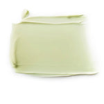Close-up of a pale green Dr Hauschka Revitalising Mask smear, spread into a broad rectangle with a smooth centre and curled edges.
