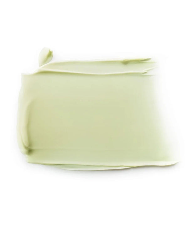 Close-up of a pale green Dr Hauschka Revitalising Mask smear, spread into a broad rectangle with a smooth centre and curled edges.