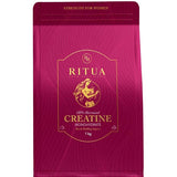 Deep pink resealable Ritua Creatine Monohydrate Strength For Women pouch with fine flowing line patterns, a gold-outlined label and a round gold emblem above the product name.