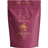 A maroon pouch labeled "Ritua Creatine Monohydrate Strength For Women" with gold text and a female athlete illustration emphasizes muscle recovery and strength, and contains 300 grams.