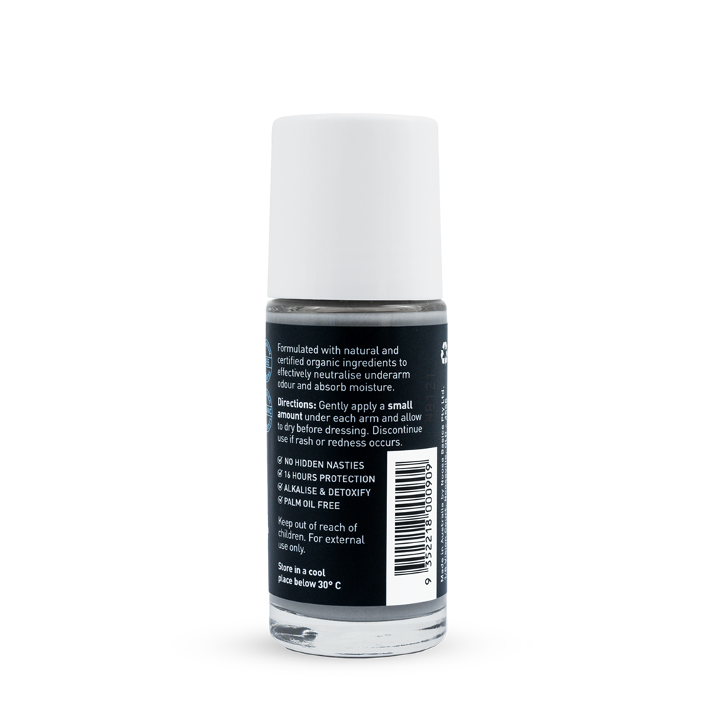 Back of a clear Noosa Basics Charcoal and Eucalyptus roll-on deodorant bottle with a white cap, showing small white directions and product information beside a barcode on its black label.