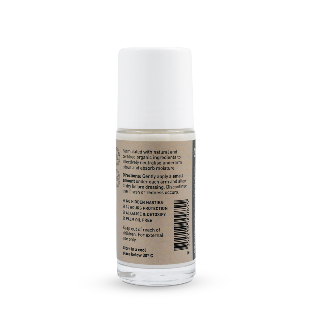 Back of a clear Noosa Basics Coconut roll-on deodorant bottle with a white cap, showing small black directions and product information beside a barcode on its beige label.