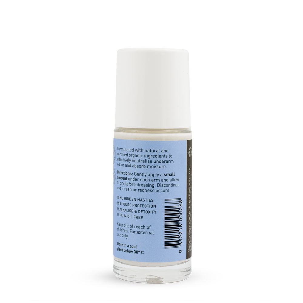 Back of a clear Noosa Basics Sweet Orange and Lavender roll-on deodorant bottle with a white cap, showing small black directions and product information beside a barcode on its pale blue label.