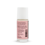 Back of a clear Noosa Basics Rose and Frankincense roll-on deodorant bottle with a white cap, showing small black directions and product information beside a barcode on its pink label.