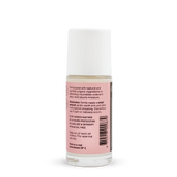 Back of a clear Noosa Basics Rose and Frankincense roll-on deodorant bottle with a white cap, showing small black directions and product information beside a barcode on its pink label.