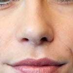Close-up of a person's face highlighting the nose, lips in a soft pink shade from Luk Beautifood Lip Nourish Lipsticks 3g, and part of the eyes. "Rose Lime" appears in the bottom left corner.