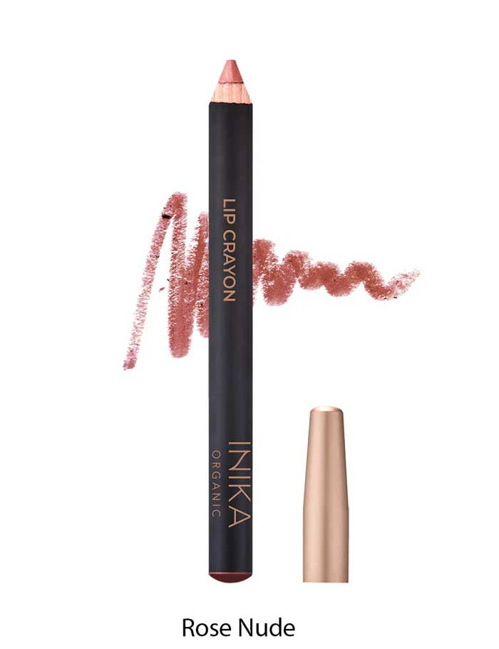 A pinkish-beige INIKA Organic Lip Crayons 6.7g with gold cap sits beside a swatch of the long-lasting liner, shade Rose Nude, written below.
