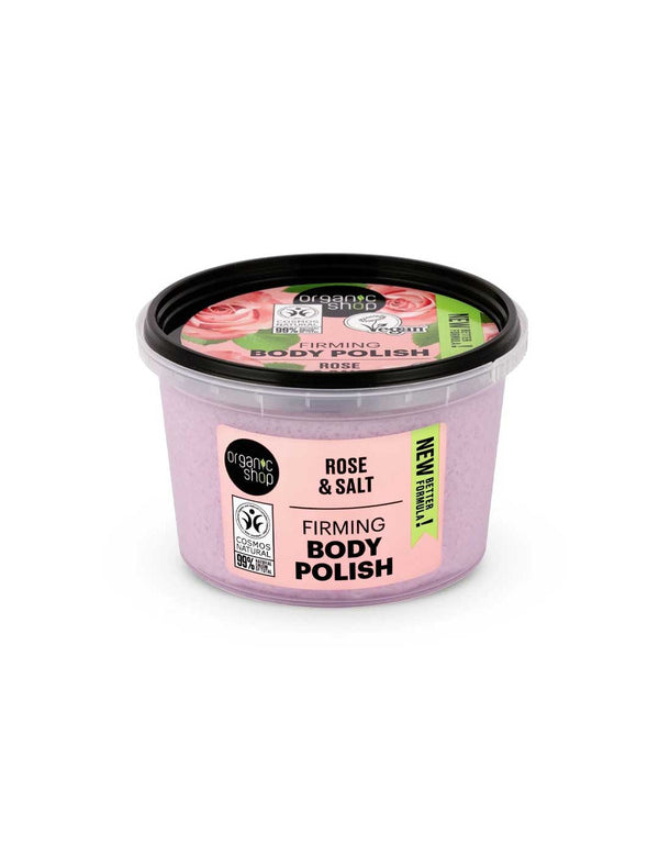 A 250ml tub of Organic Shop Rose and Salt Firming Body Polish features a black lid and pink rose-themed label on a white background. The organic formula blends rose hydrolate and natural salt for radiant, firmer skin.
