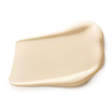 Close-up of a thick ivory Dr Hauschka Rose Nurturing Body Cream smear shaped into a broad rectangle with high curved edges.