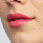 Model wearing Antipodes Moisture Boost Natural Lipstick in South Pacific Coral