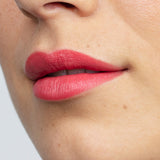 Model wearing Antipodes Moisture Boost Natural Lipstick in South Pacific Coral