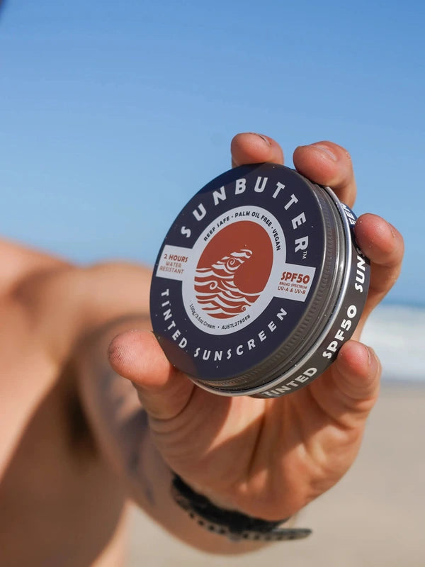 SunButter Tinted Sunscreen SPF50 held in hand