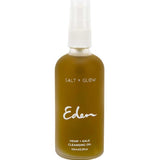 Rounded Salt + Glow Eden cleansing-oil bottle filled with olive-green liquid, with a white pump under a clear cover and the Eden name printed in white script.