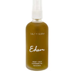 A 100ml clear bottle labeled "Salt + Glow Eden Cleansing Oil" with a white spray cap holds a nourishing hemp and kale blend, serving as an effective makeup remover.