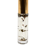 A clear glass Salt + Glow Elixir Roll on Perfume - Breathe (Lavender & Peppermint) 10ml features a gold cap, transparent liquid with botanical pieces, and is handmade in Australia.