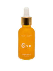 A yellow glass dropper bottle with a gold cap, labeled Salt + Glow Ora Ultimate Facial Oil 30ml—a superfood face oil for radiant, healthy skin.