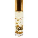 Salt + Glow Elixir Roll on Perfume - Restored (Frankincense & Chamomile) 10ml is a handmade vegan fragrance in a small clear bottle with gold flakes. Relaxing aromatherapy benefits come from soothing frankincense and chamomile oils.
