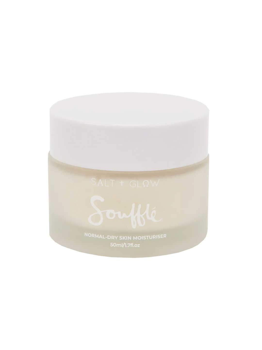 A frosted glass jar with a white lid labeled Salt + Glow Skin Souffle Facial Moisturiser for normal to dry skin, enriched with Australian botanicals like kakadu plum, 50ml/1.7 fl.oz.