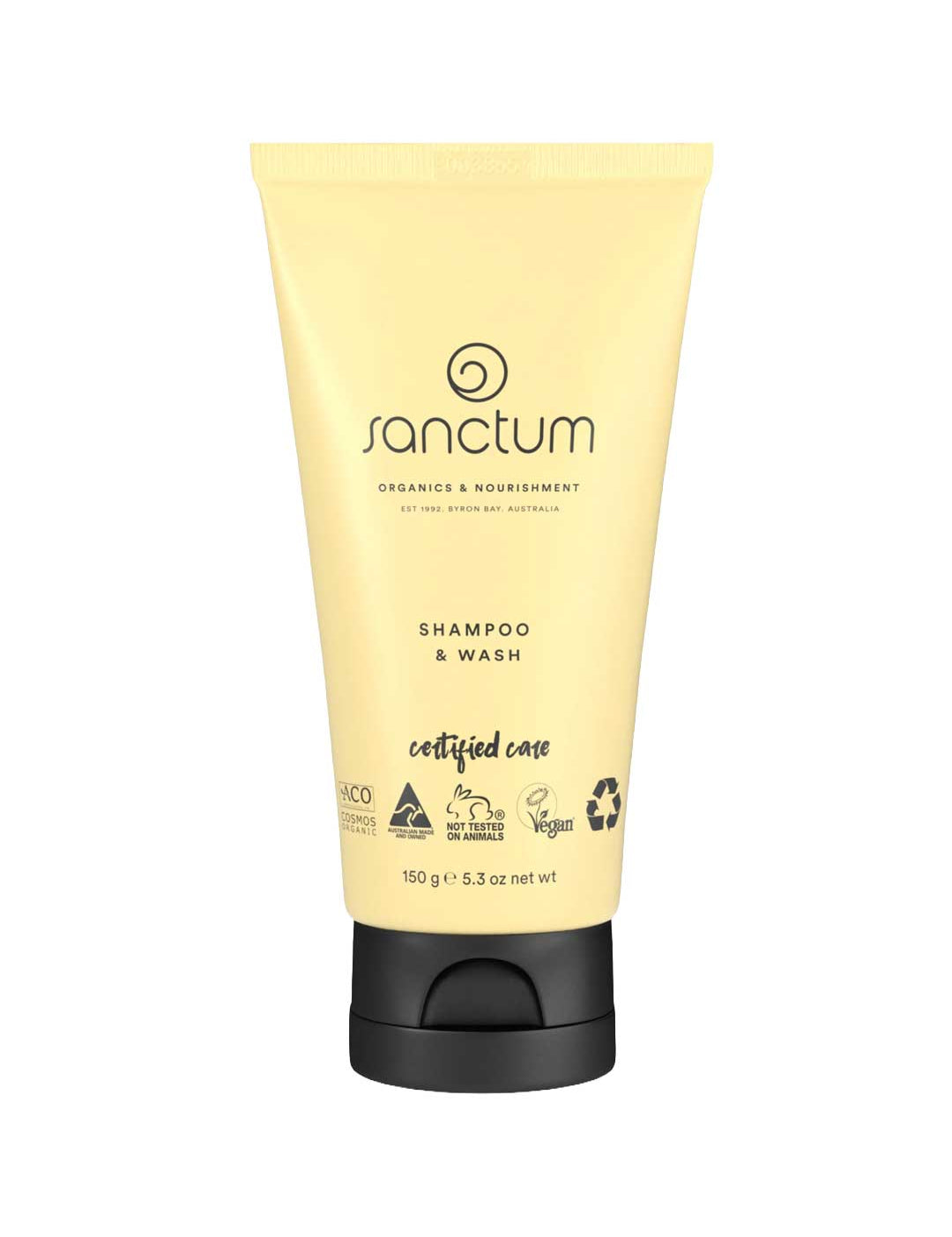 A yellow 150g tube of Sanctum Baby Shampoo & Wash with a black flip-cap. The front label shows vegan, organic, cruelty-free, and recyclable packaging certification logos.