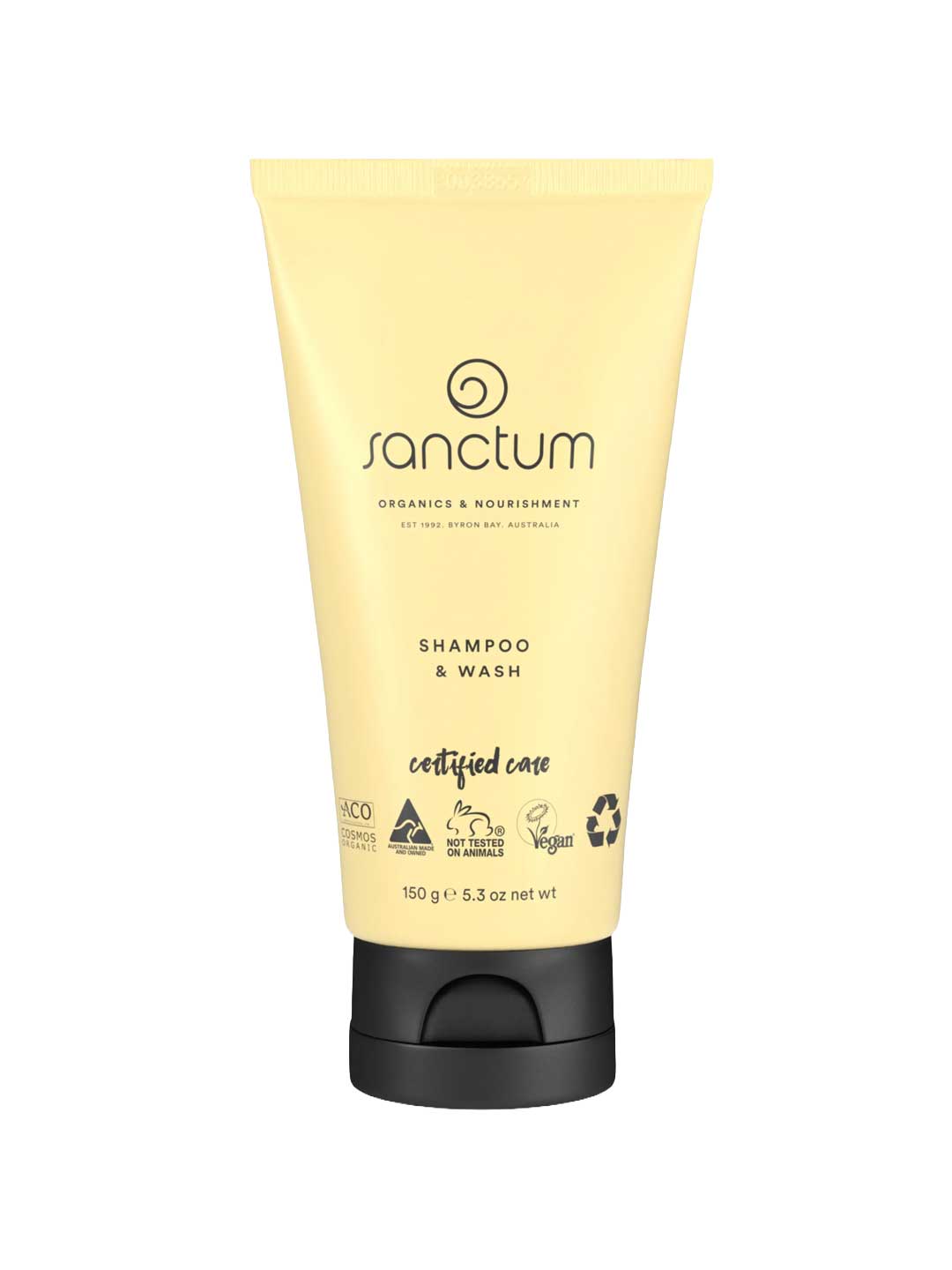 A yellow 150g tube of Sanctum Baby Shampoo & Wash with a black flip-cap. The front label shows vegan, organic, cruelty-free, and recyclable packaging certification logos.