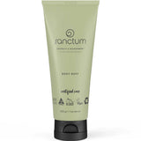 A green 200g Sanctum Body Buff tube stands upright with vegan, cruelty-free, and recyclable certifications on it. The tube features a black flip-top cap and the Sanctum brand label.