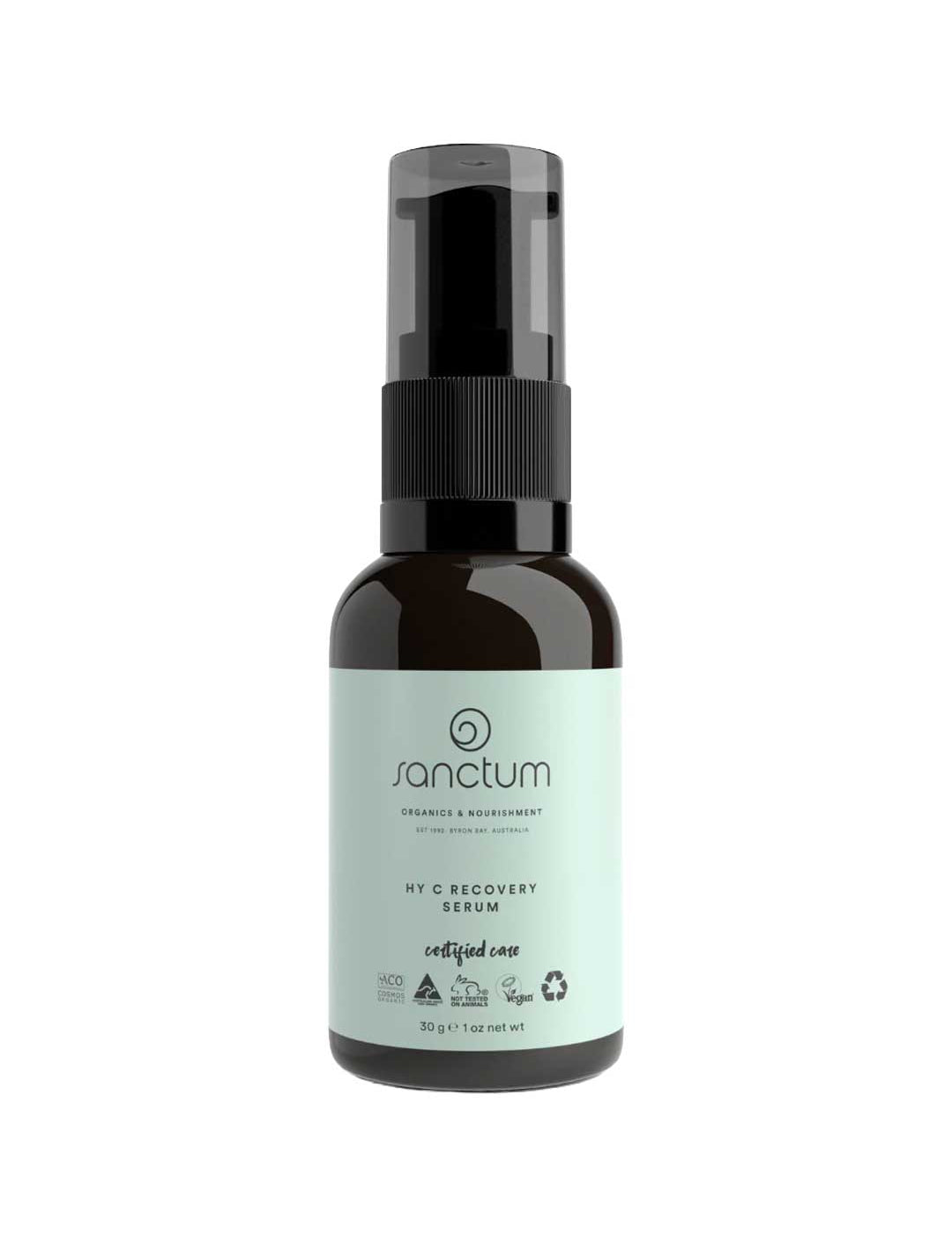 A dark amber pump bottle labeled Sanctum HY C Recovery Serum 30g features a light green label with certification and recycling symbols. This organic Vitamin C serum from Sanctum offers anti-aging benefits for natural skincare.
