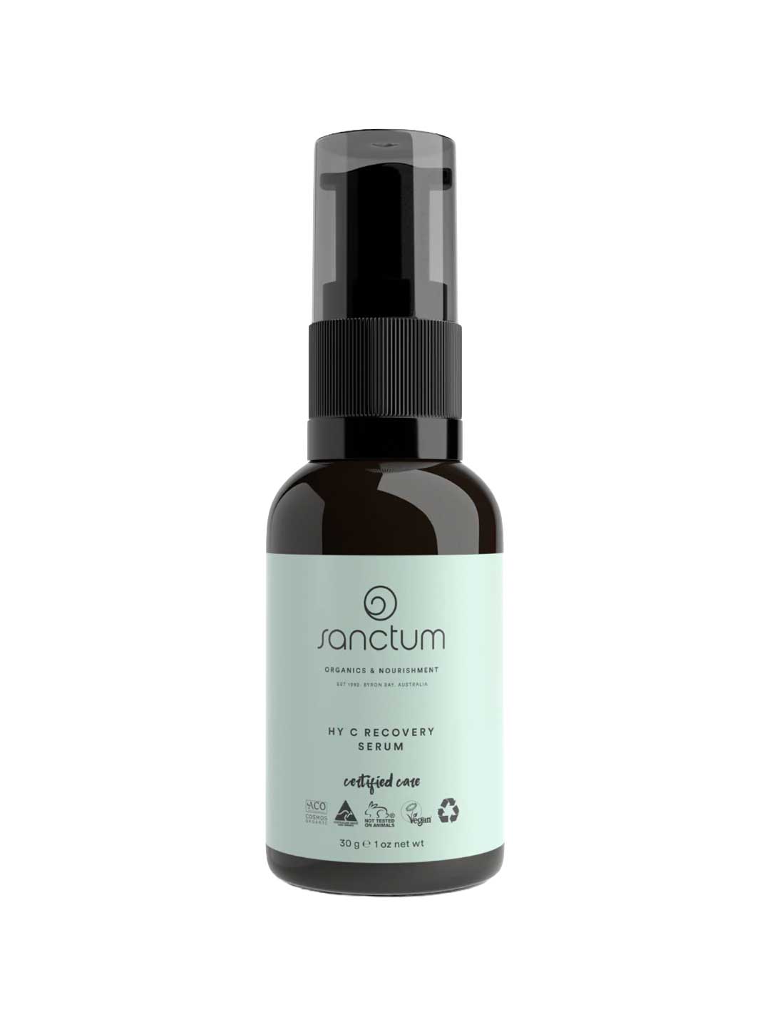 A dark amber pump bottle labeled Sanctum HY C Recovery Serum 30g features a light green label with certification and recycling symbols. This organic Vitamin C serum from Sanctum offers anti-aging benefits for natural skincare.