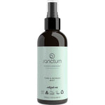 A dark brown spray bottle with a light blue label reading "Sanctum Tone & Refresh Mist 200g," featuring "Hydrating Face Mist" in small text, along with organic certification and recycling symbols below the main label.
