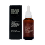 Back of an amber Noosa Basics Scalp Serum bottle beside its black carton, showing white application directions and care instructions.
