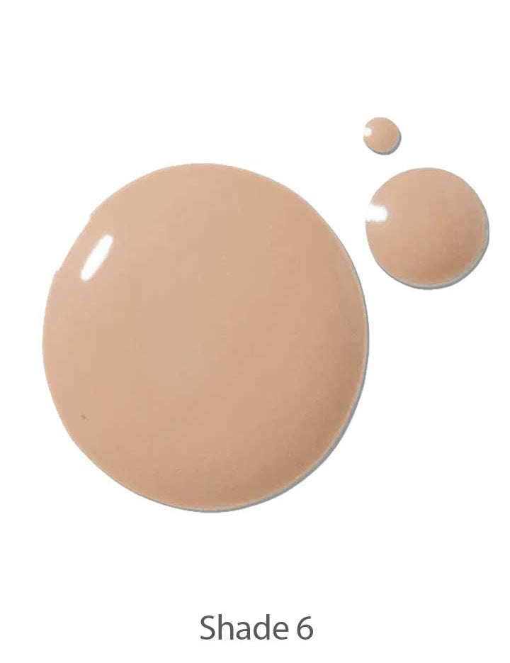 Three drops of 100% Pure 2nd Skin Serum Foundation 35ml in Shade 6 sit on a white background—the largest leftmost, two smaller to the right—highlighting the brand’s lightweight, seamless natural finish.