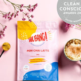 She BANG! Peri Chai Latte pouch styled with a prepared latte and botanicals