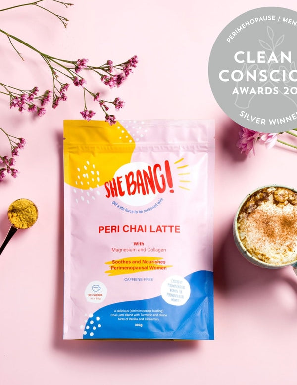 She BANG! Peri Chai Latte pouch styled with a prepared latte and botanicals