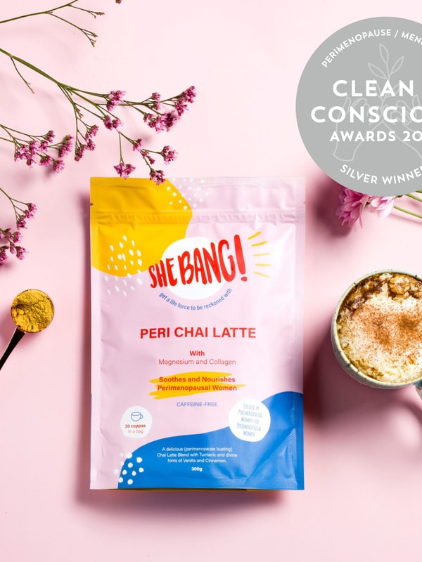 She BANG! Peri Chai Latte pouch styled with a prepared latte and botanicals