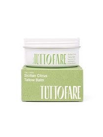 A white jar of Tuttofare Sicilian Citrus Tallow Balm 70g, made with hydrating grass-fed beef tallow, sits on a green box. The minimalist packaging highlights bergamot and green mandarin among its key ingredients.