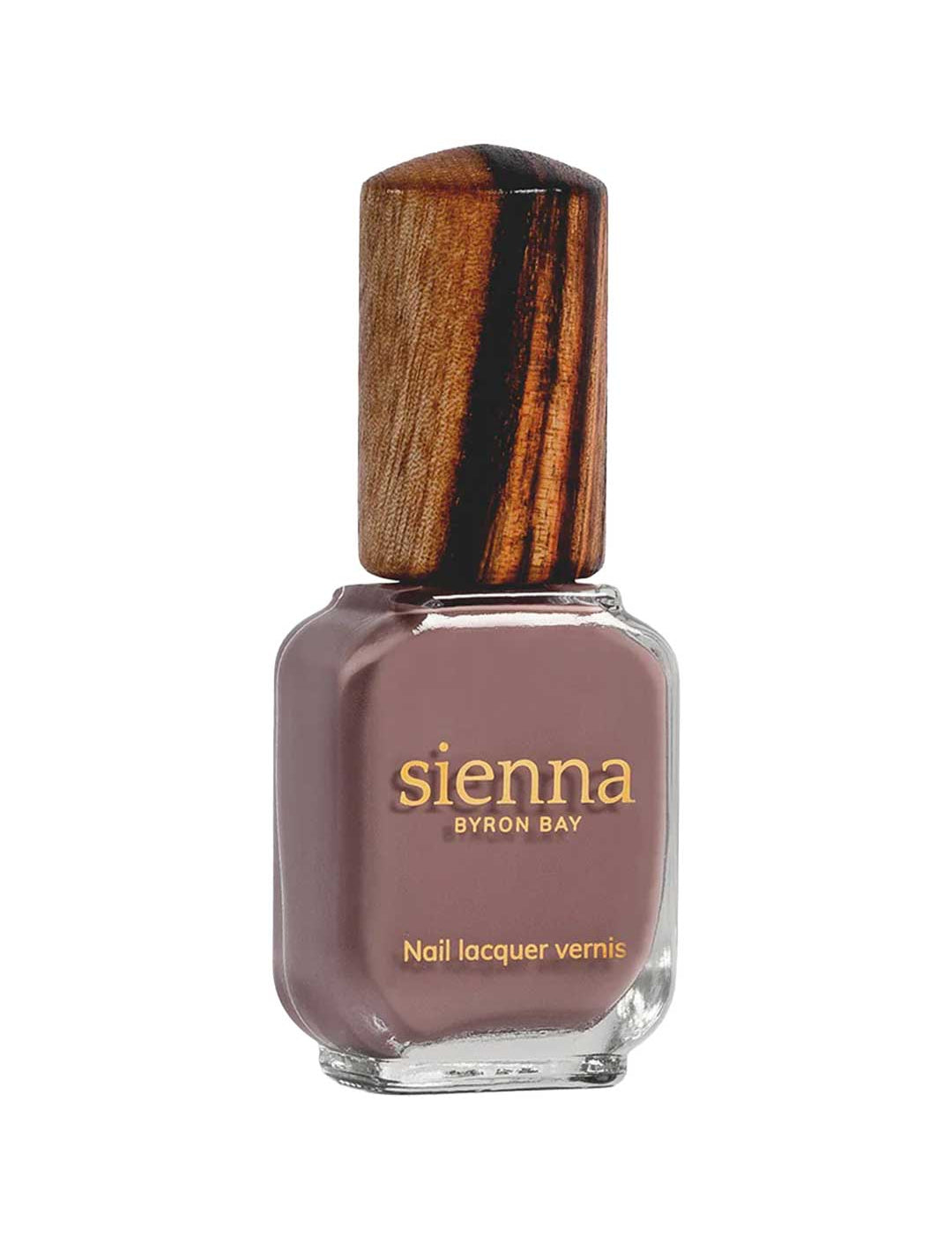 A rectangular glass bottle of Sienna Byron Bay Nurture nail polish, featuring a brownish-mauve shade, gold label with brand and product info, and a wooden cap.