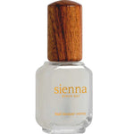 A clear glass bottle of Sienna Byron Bay Matte Top Coat with a wooden cap. The yellow label reads sienna BYRON BAY and Matte Top Coat. The bottle holds a white or pale matte top coat nail polish.