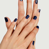 Two hands with neatly manicured nails, finished with Sienna Byron Bay Matte Top Coat by Sienna Byron Bay, are crossed over each other against a light background.