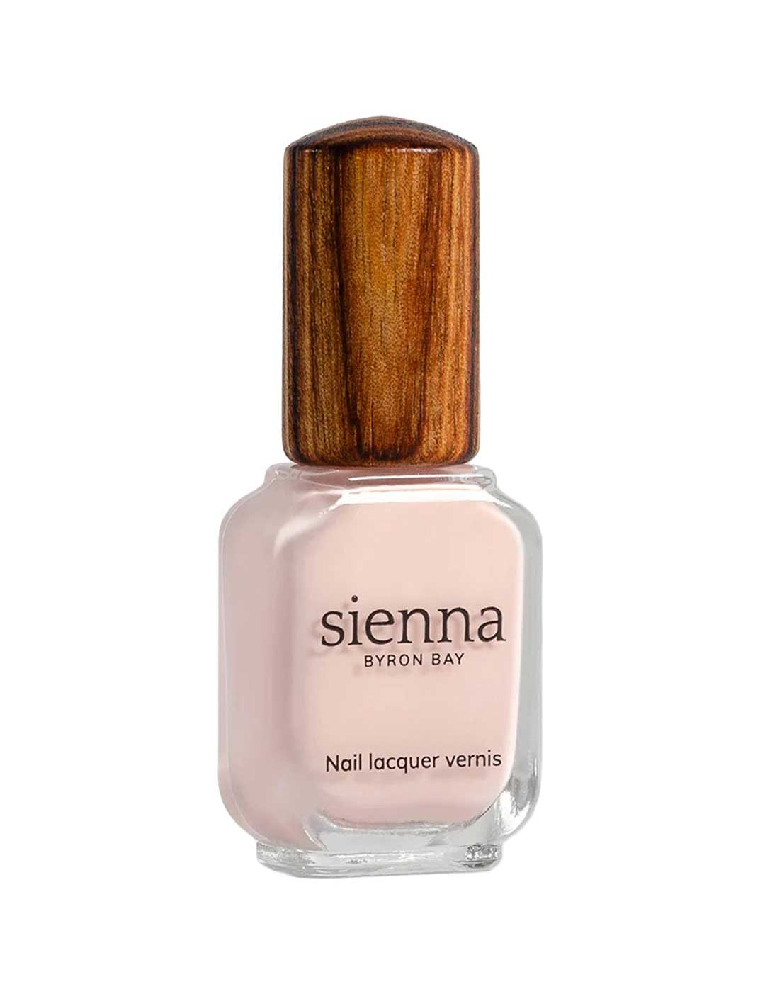 A bottle of Sienna Byron Bay Melody nail lacquer with light pink polish and a wooden-textured cap is shown against a white background.