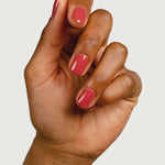 A hand with medium brown skin tone is shown against a white background, displaying neatly manicured nails painted with Sienna Byron Bay Muse by Sienna Byron Bay.