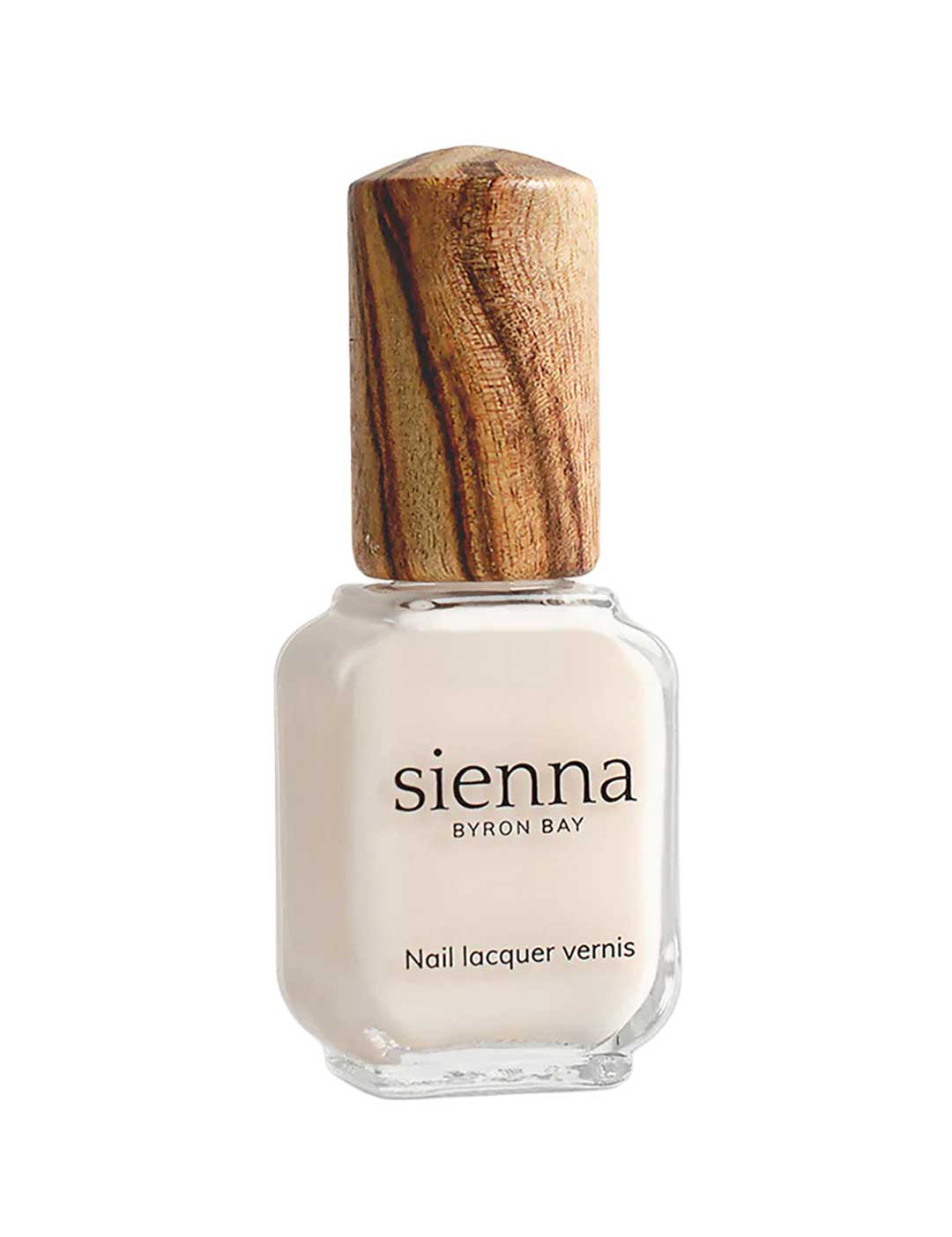 A bottle of Sienna Byron Bay - Hope nail lacquer with off-white polish, a wooden cap, and labeled "Nail Lacquer Vernis" from Sienna Byron Bay.