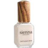 A bottle of Sienna Byron Bay - Hope nail lacquer with off-white polish, a wooden cap, and labeled "Nail Lacquer Vernis" from Sienna Byron Bay.
