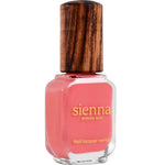 A bottle of Sienna Byron Bay Laughter nail lacquer with a pink shade and wooden cap, featuring gold text on the front of the glass container.